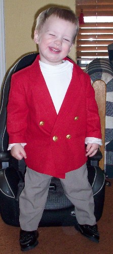 Hayden poses in a red jacket from Gummy, 26 months