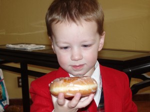 hayden gazing intently at a donut