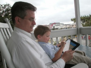 Hayden with two of his faves: Papa and the iPad